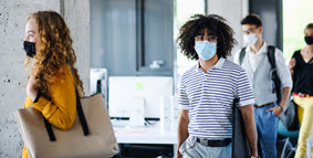 young people walking wearing masks