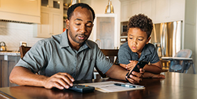 A dad teaching son about financial topics