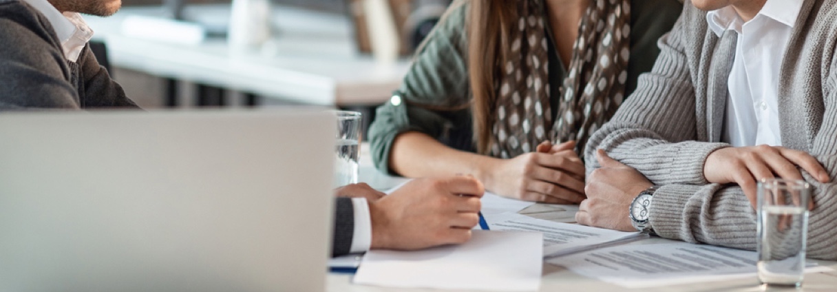 Two people being consulted by a loan officer