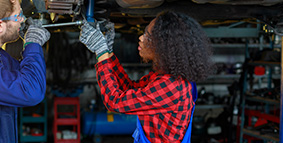 Two young people working in a mechanic shop