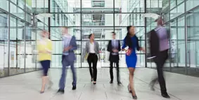 People walking through an office building