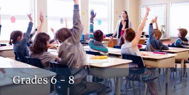 students in class raising hands